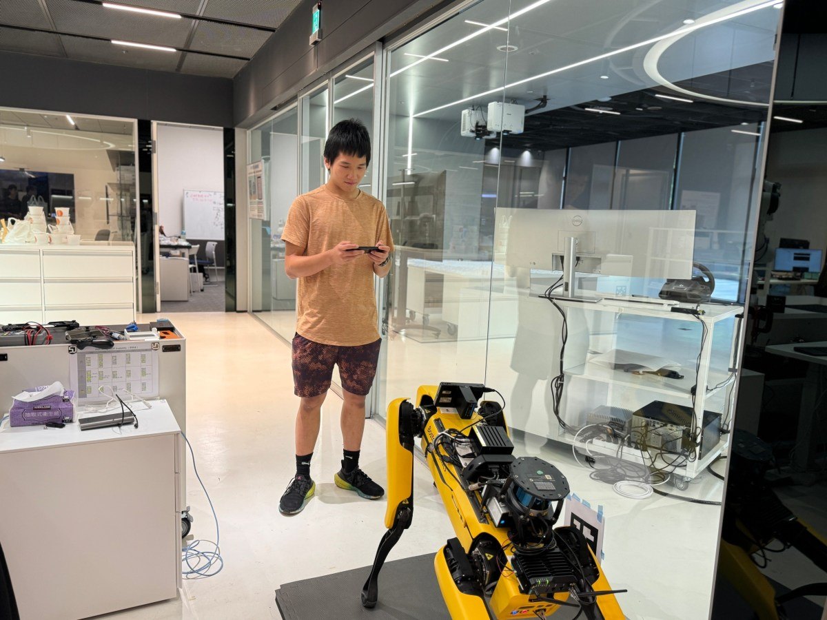Owen testing a yellow quadruped robot in the MIT City Science Lab